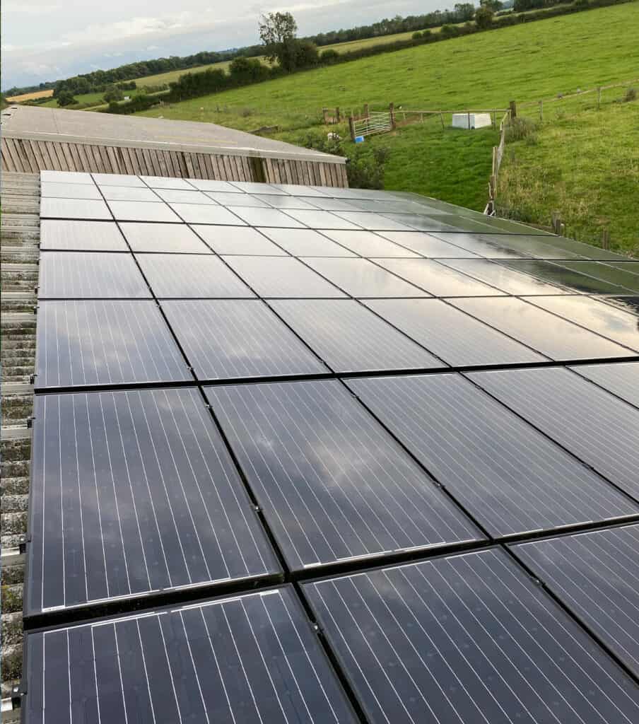 A farmhouse in Bedfordshire, England with a large solar panel rack, cleaned by EV Solar