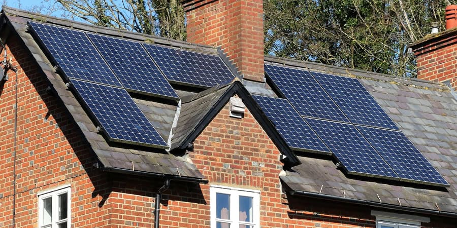 A red brick cottage near Peterborough, England with solar panels on a tile roof