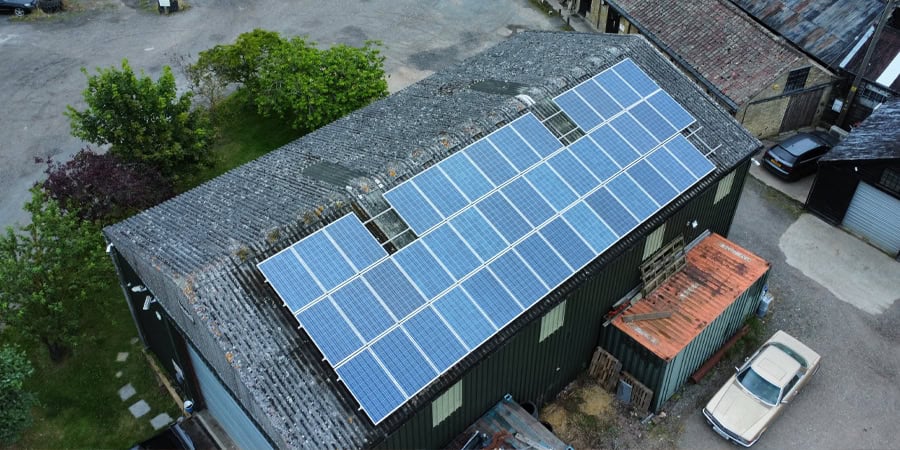 A rural farm in Cambridgeshire with a large array of solar panels on the roof